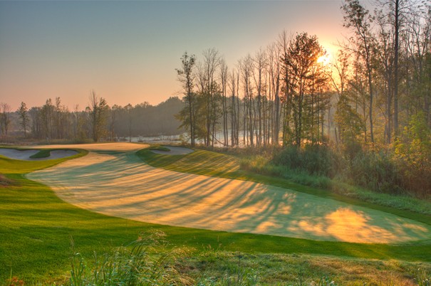 Morning sun shining on the Kaluhyat golf course through the woods
