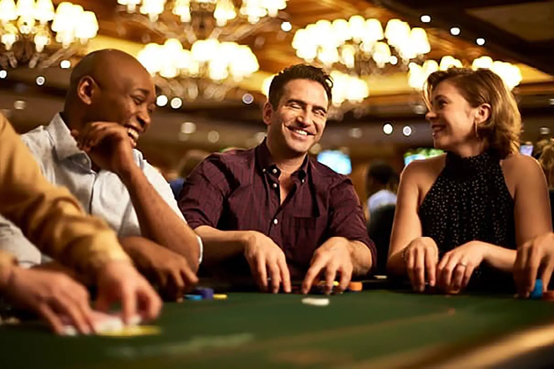 Friends laughing at a poker table