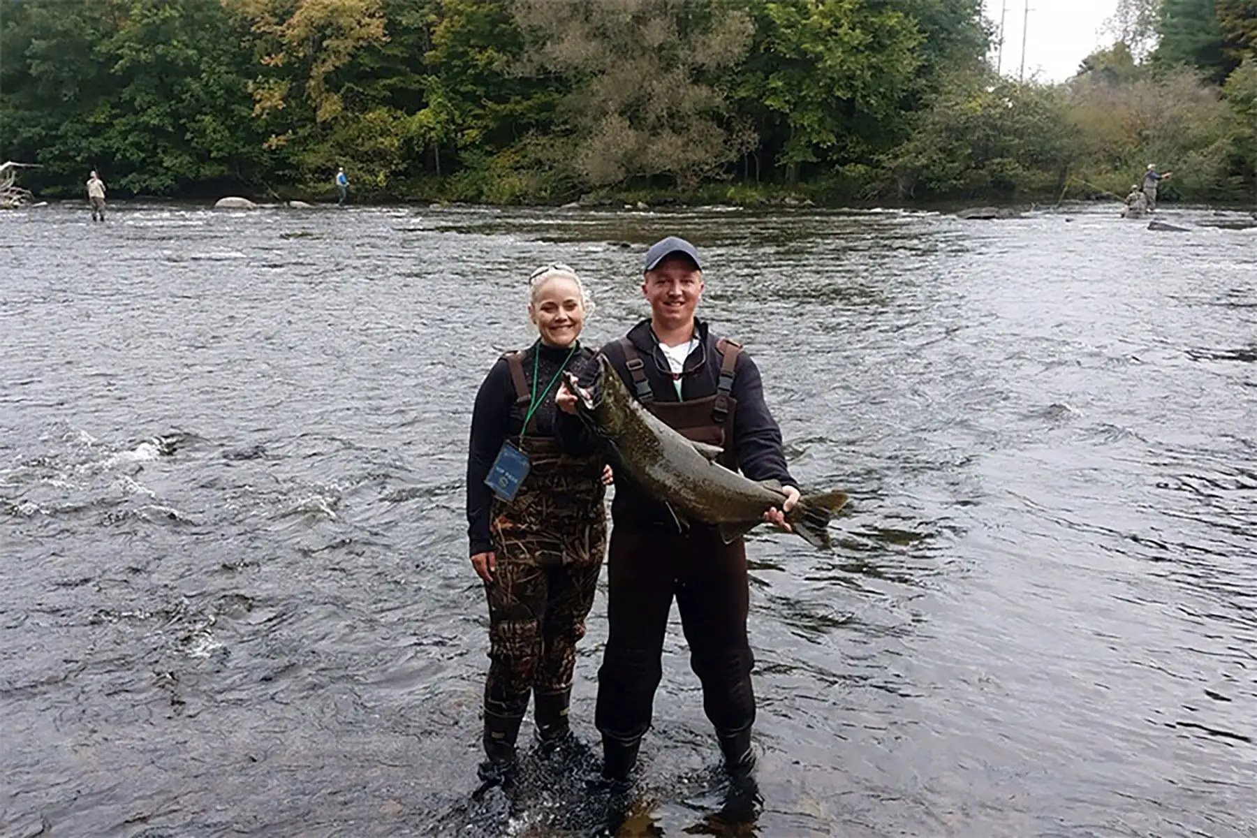 Couple with a fish on the river