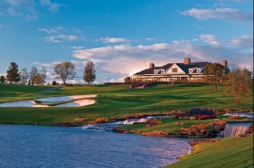 Panoramic view of Atunyote and Clubhouse with streams falling in to pond in evening sunlight