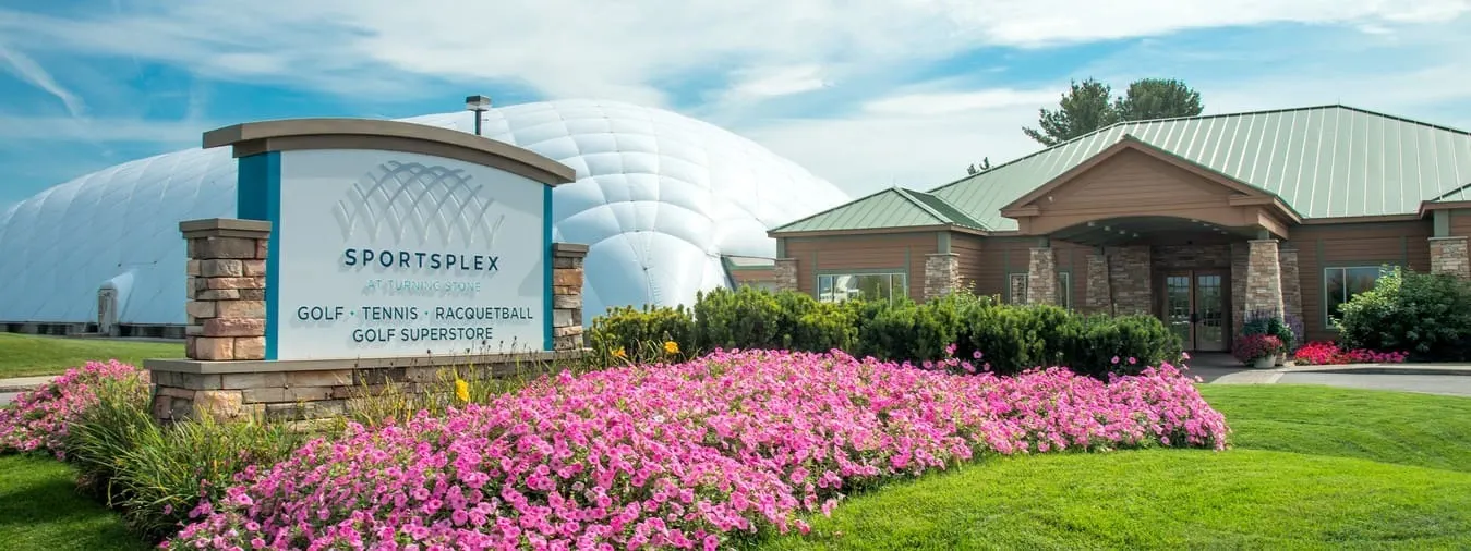 Flower lined entrance to the Sportsplex for golf, tennis, and racquetball at Turning Stone