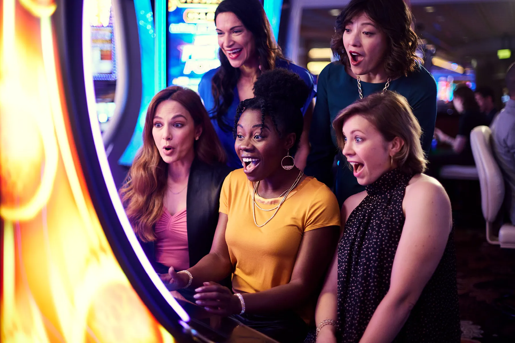 excited group playing slot machine